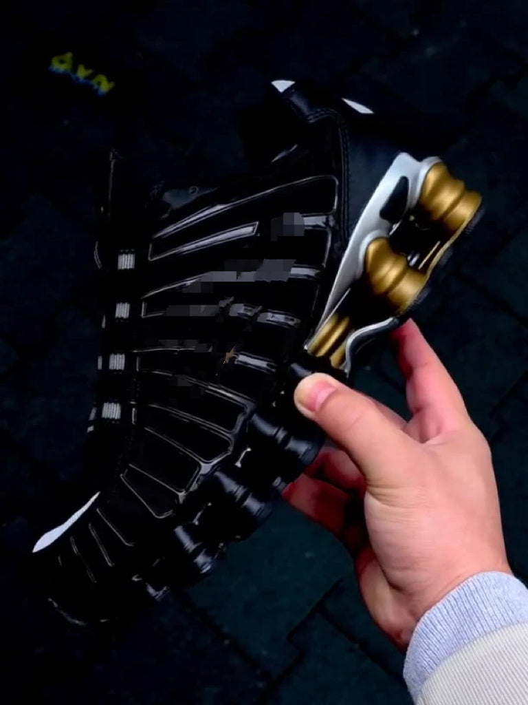Black sneakers with gold accents