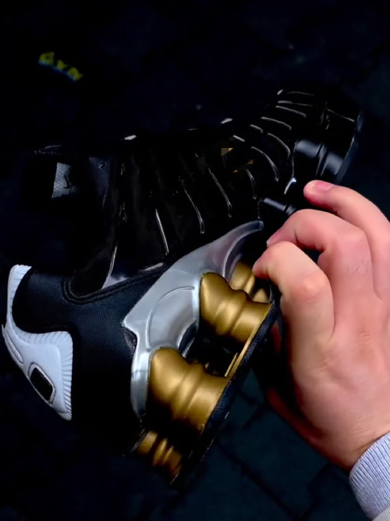 Black sneakers with gold accents